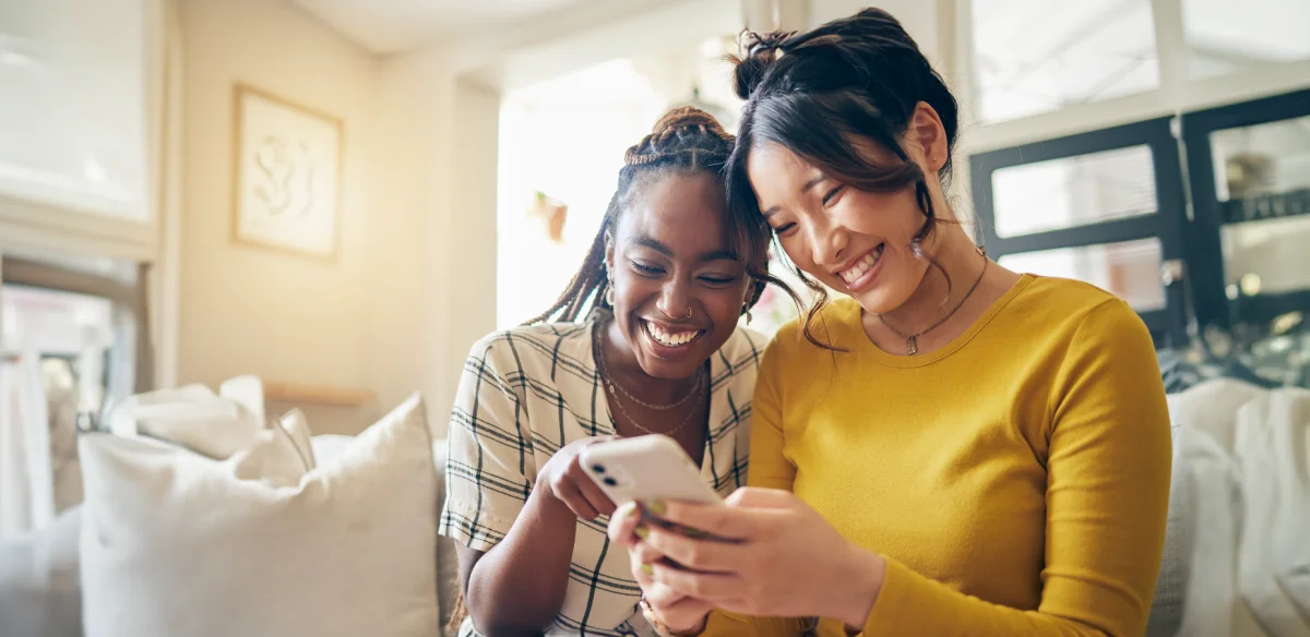 Student smiling while looking at their cellphone