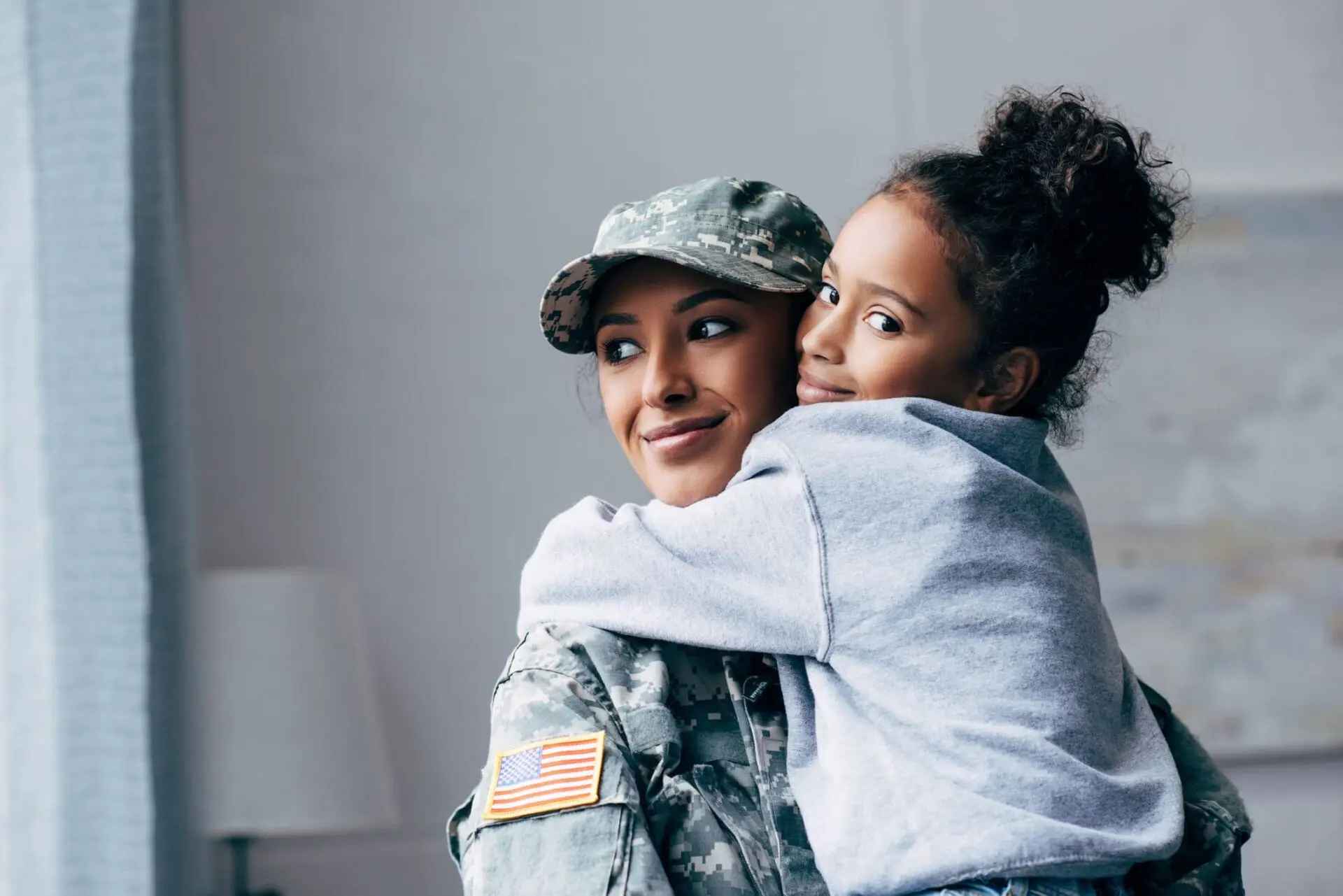 military woman with little girl